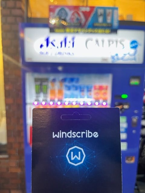 Photo of Japanese Vending Machine with a Windscribe code card held in front