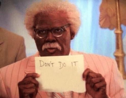 Man holding sign that says don't do it